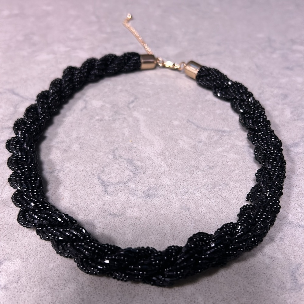Black beaded twisted necklace with gold hardware